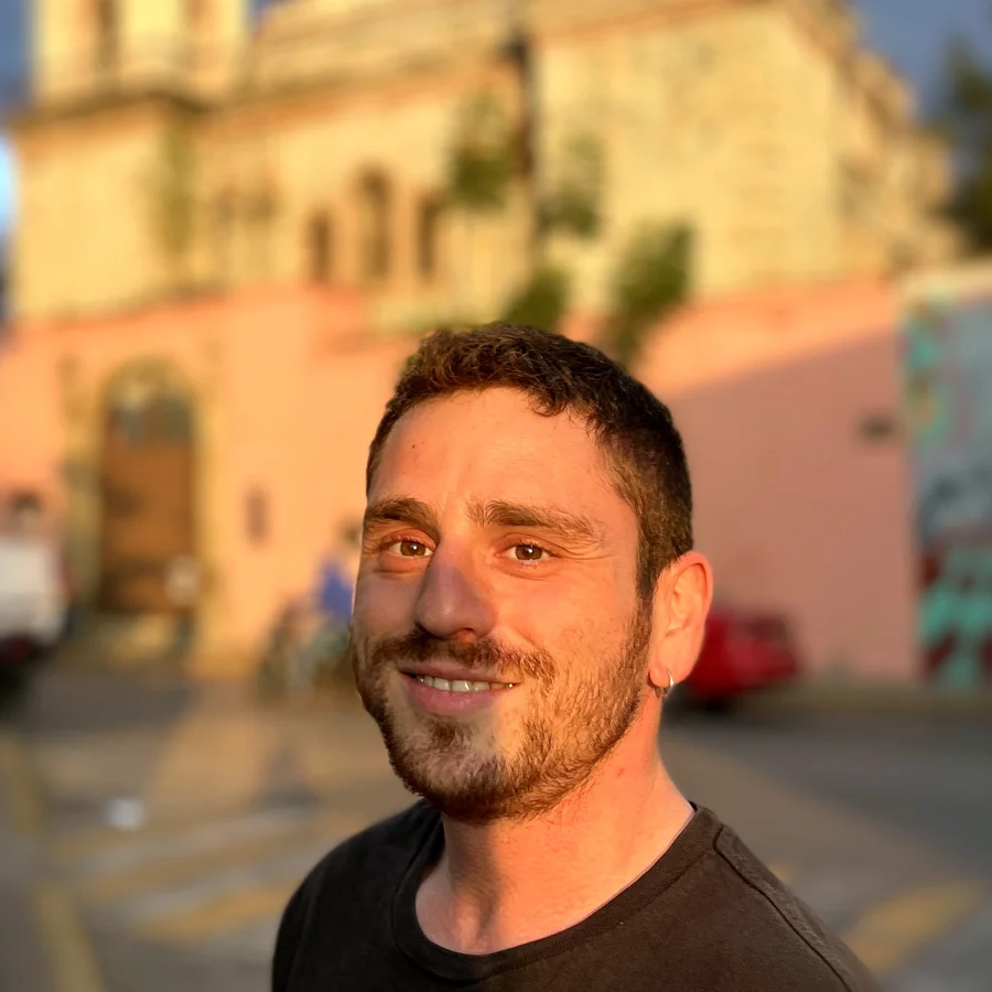 Yann Darmon smiling at the camera on a street in Mexico